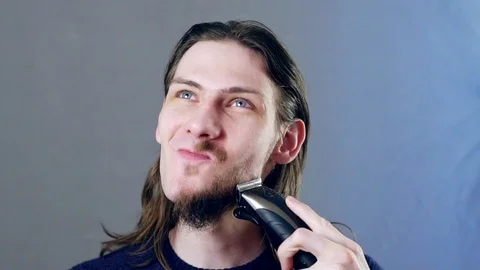 Man shaves beard Stock Footage 104947563