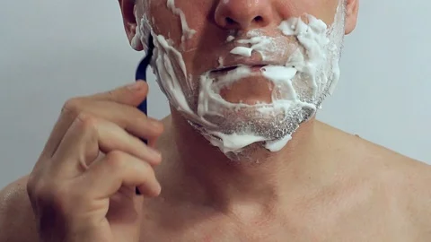 Man shaves a cheek-off machine Stock Footage 106674417
