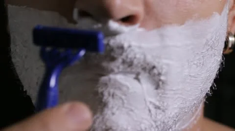 Man shaves disposable razor close up Stock Footage 11894656