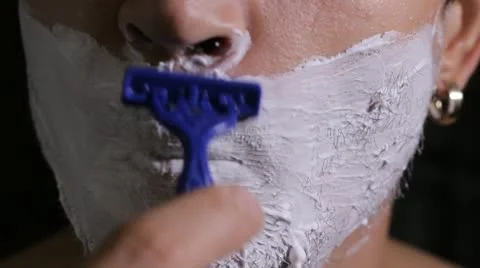 Man shaves disposable razor close up Stock Footage 11894669