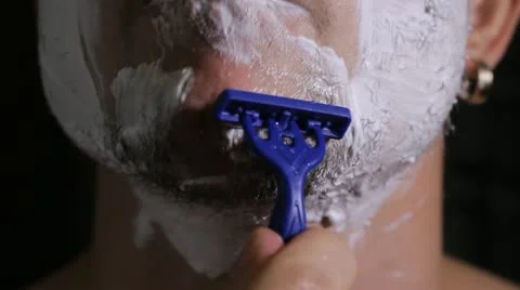 Man shaves disposable razor close up Video stock 11894670