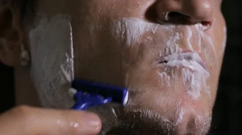 Man shaves disposable razor close up Stock Footage 11894722