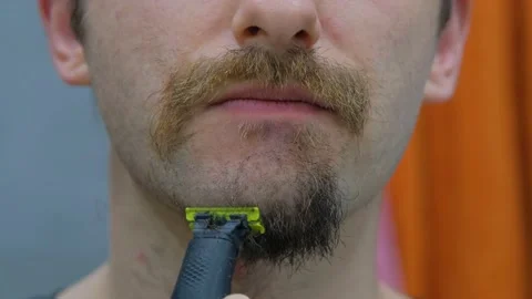 A man shaves his beard close-up. The process of shaving the beard close-up Stock Footage 231495550