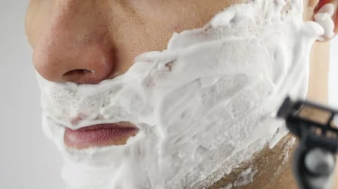 Man shaves his face. Video stock 68970127