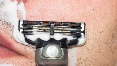 A man shaves the machine. Stock Photos