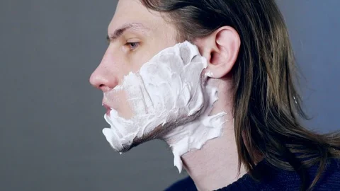 A man shaves with a razor Stock Footage 104947588