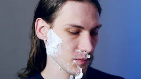 A man shaves with a razor Stock Footage 104947739