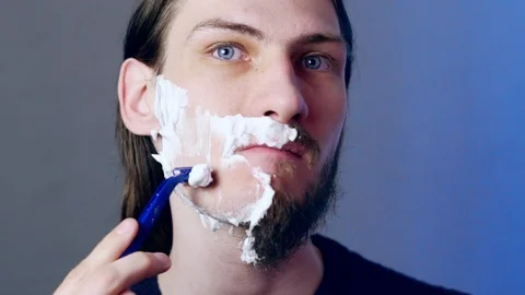 A man shaves with a razor Stock Footage 116244681