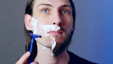 A man shaves with a razor Stock Footage 116547780