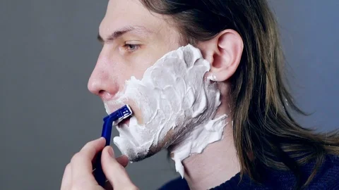 A man shaves with a razor Stock Footage 116547862