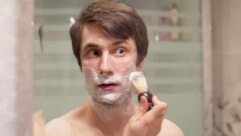 Man shaving in the bathroom Stock Footage 128916788