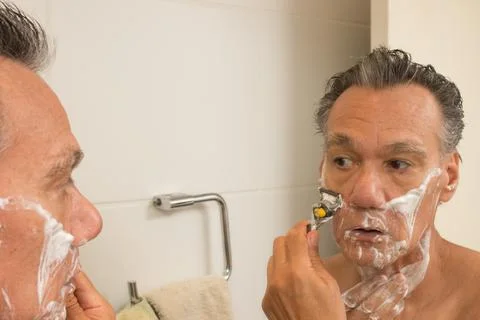 Man Shaving in the Bathroom Stock Photos