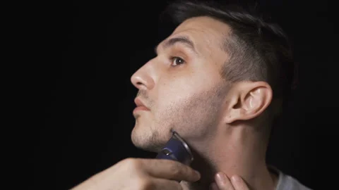 Man shaving beard and trimming sideburns. Facial hair shaving concept Stock Footage 131509121