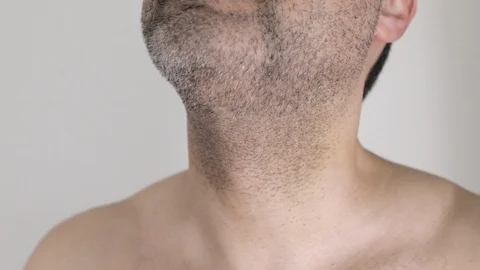 Man shaving beard with an electric razor Video stock 103152529