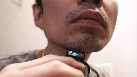 Man shaving beard with trimmer. Stock Footage 287279702