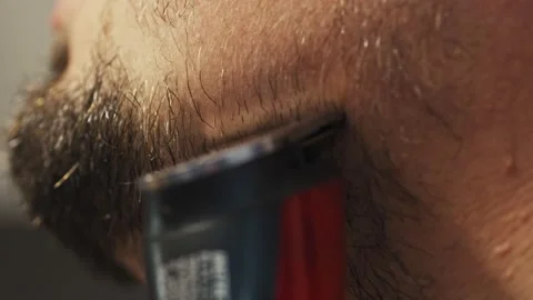 Man shaving beard using electric trimmer shaver. Male beauty grooming concept. Stock Footage 147207660