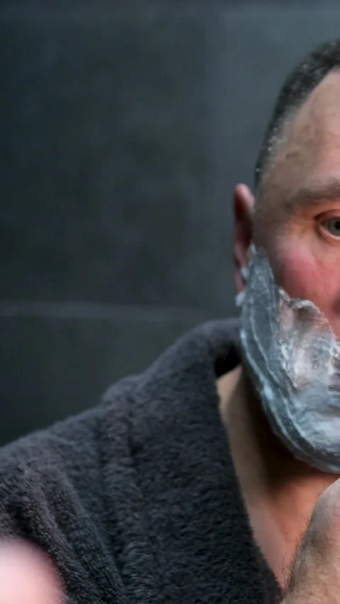 Man shaving beard using electric trimmer shaver. Male beauty grooming concept Stock Footage 302066363
