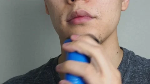 Man shaving bread using electronic shaver close up Video stock 130067880