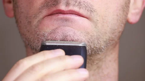 Man shaving with electric razor Stock Footage 149295445