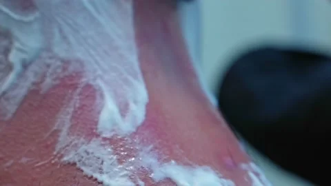 Man with shaving foam on his head shaving his hair with a machine with shaving Stock Footage 218959282