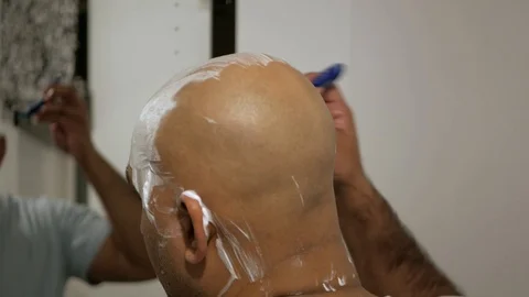 Man shaving front of head Stock Footage 119257528