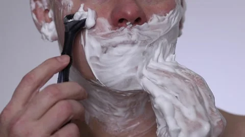 The man is shaving. Front view, extreme close up. Stock Footage 223503620