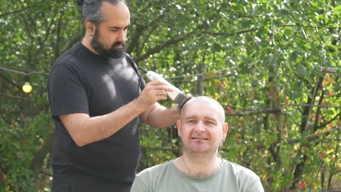 Man shaving head with clippers, time-lapse haircut Stock Footage 318219614