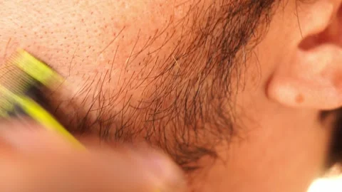 Man shaving his beard and wiping his face with his hand Stock Footage 287512593