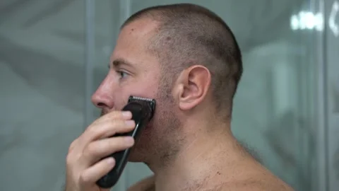 Man Shaving His Beard with an Electric Trimmer Close Up Stockbeeldmateriaal 342662217