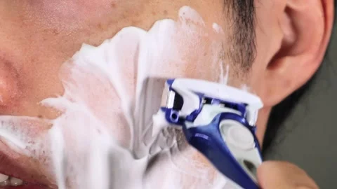 A man shaving his beard Stock Footage 336577471