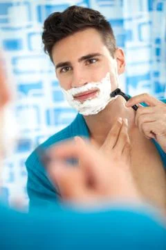 Man shaving his beard Stock Photos