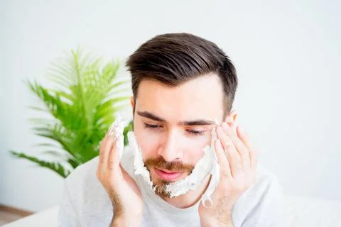 Man shaving his beard Stock Photos