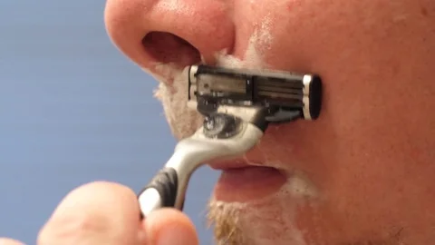 Man shaving his face in macro close up Video stock 81494053