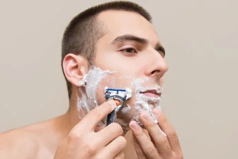 The man is shaving Stock Photos