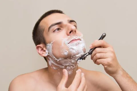 The man is shaving Stock Photos