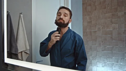 Man shaving using electric razor Stock Footage 107323909