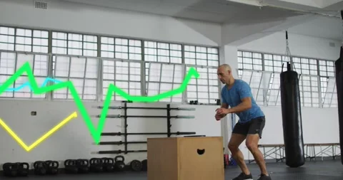 Man shifting weight, jumping down, rebounding onto box for fitness training Stock Footage 330602440