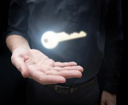 Man with shining key Stock Photos