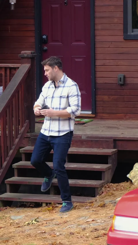 A man in a shirt drinking hot tea from a mug in the morning at the shallet house Stock Footage 295165784