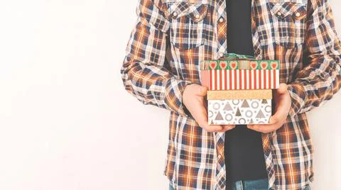 A man in a shirt holds various gift boxes Stock Photos