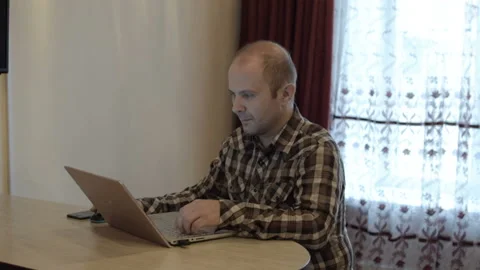 A man in a shirt works at the computer. Video stock 96114775