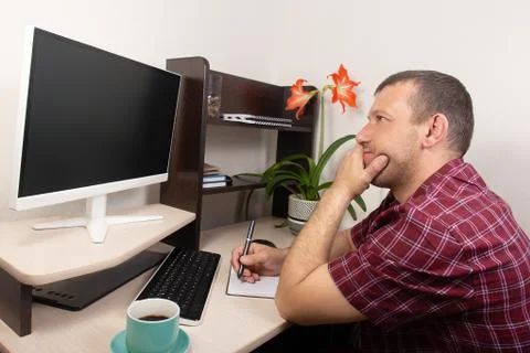 Man in shock, at home at the computer Stock Photos