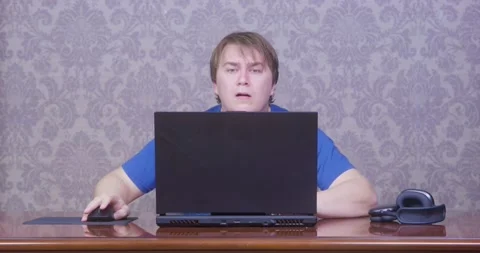 Man shocked at computer screen in home office Stock Footage 293527265