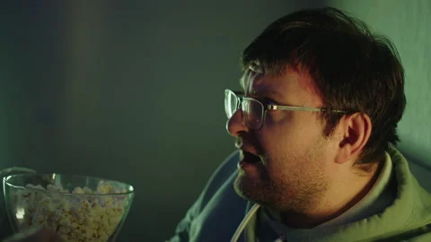 Man shocked while watching TV program in the evening in living room 库存影片 314396646