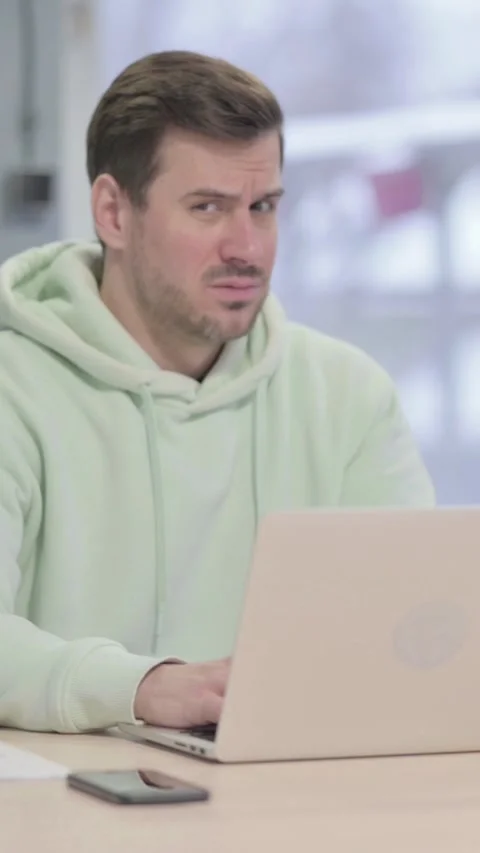 Man Shocked While Working on Laptop, vertical video 库存影片 329104958
