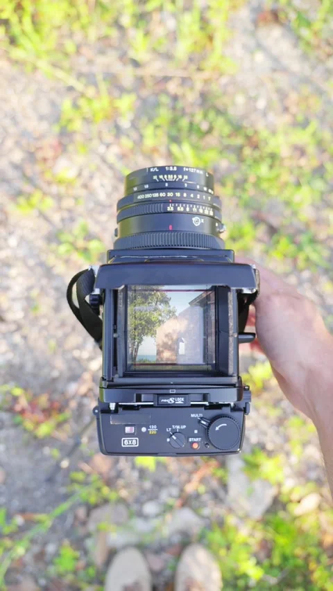 A man shoot on vintage medium format camera Stock Footage 312910500