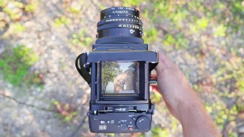 A man shoot on vintage medium format camera Stock Footage 314088614