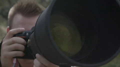 Man shooting with big camera lens Stock Footage 54708204