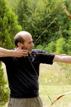Man shooting with bow Stock Photos