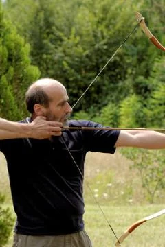 Man shooting with bow Stock Photos